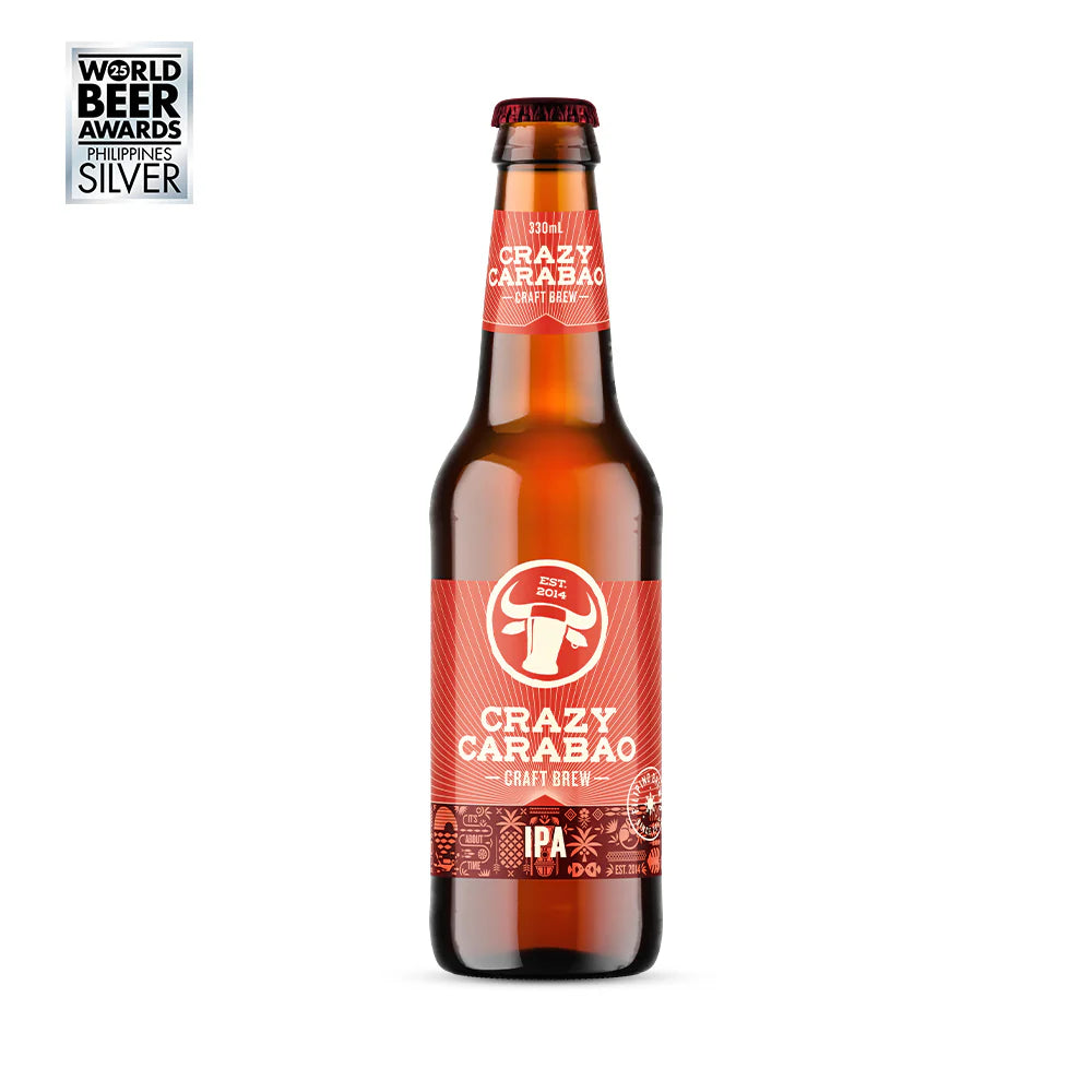 A bottle of Crazy Carabao Craft Brew IPA on a white background, featuring a brown glass bottle with a red label and a silver World Beer Awards Silver badge in the top-left corner.