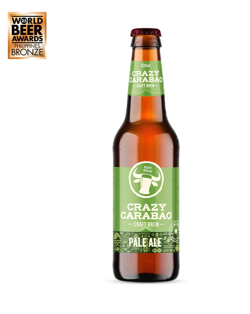 A bottle of Crazy Carabac Pale Ale craft brew, featuring a green label and brown glass bottle, shown on a white background with a World Beer Awards Bronze award badge in the top-left corner.